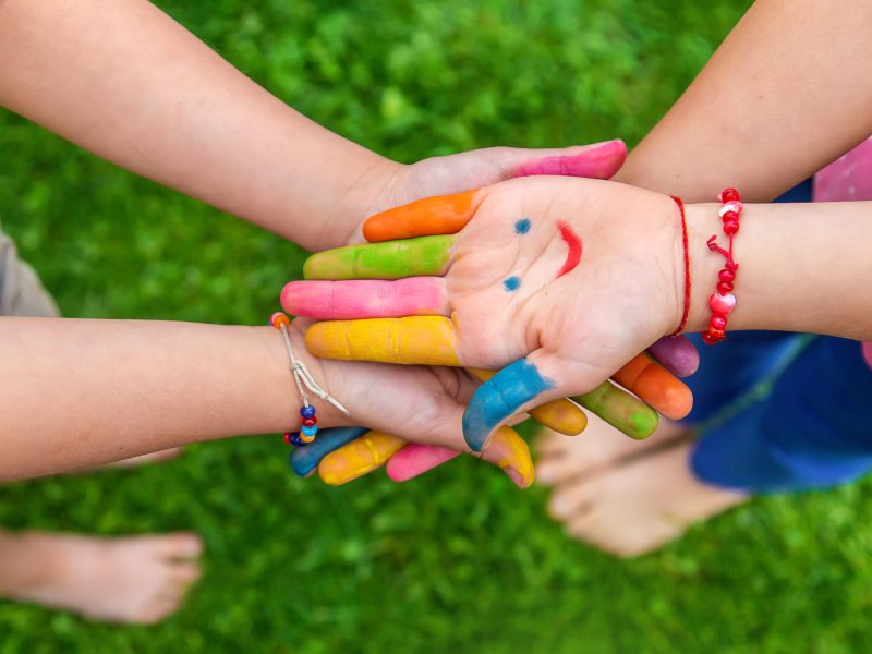Hands of a child with a drawn emoticon. Selective focus.