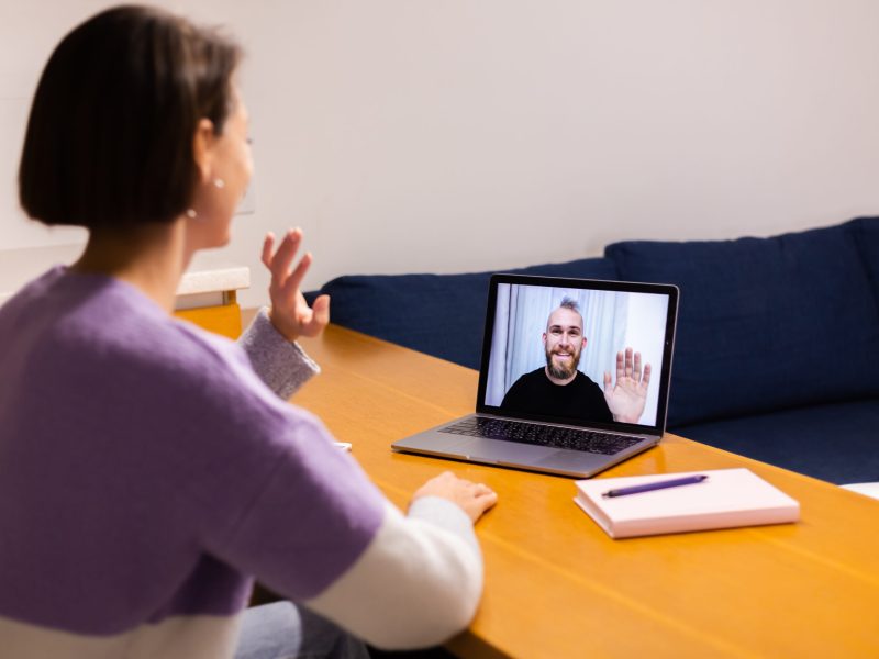 Woman at home face time video call her friends husband boyfriend, chatting online from laptop